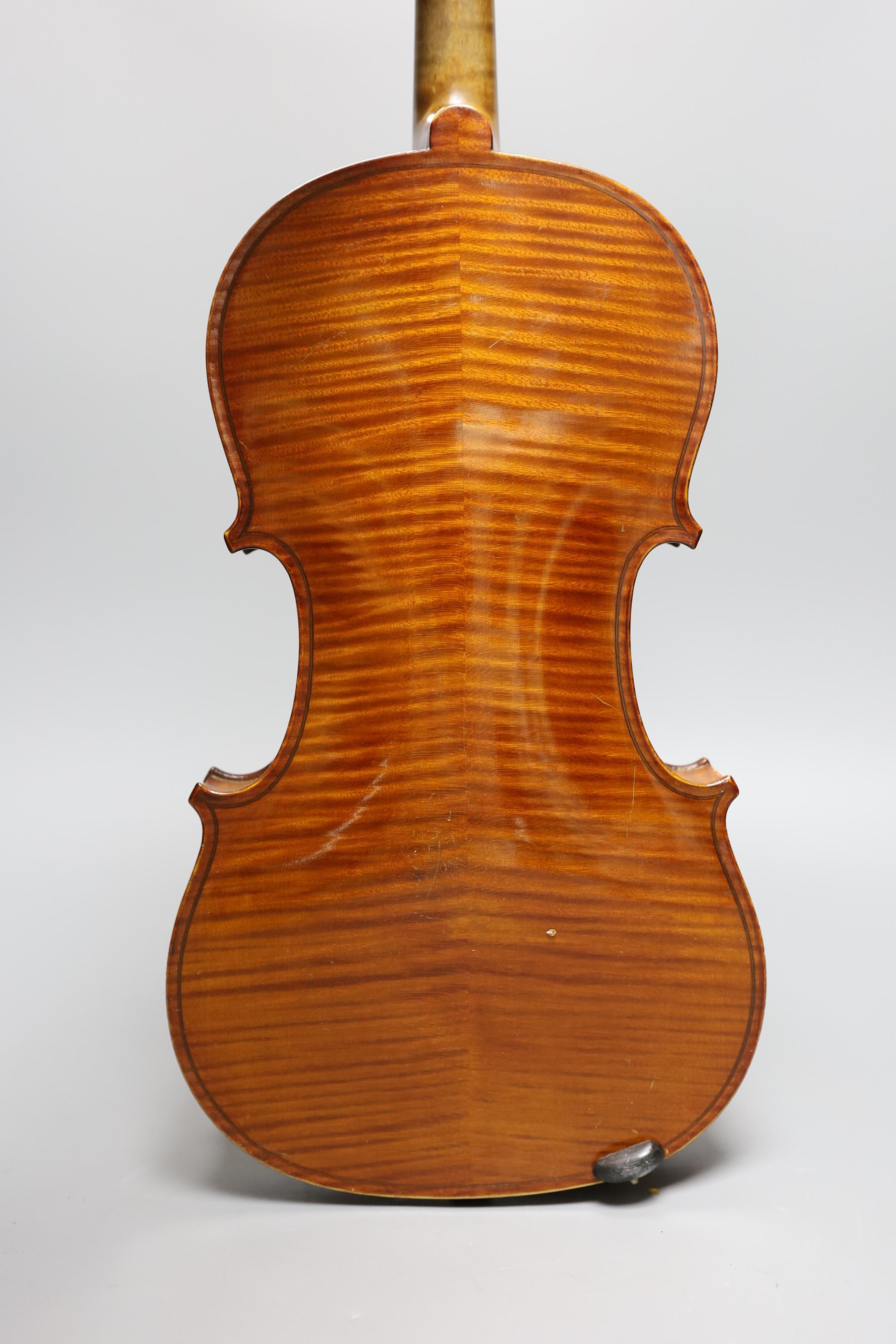 No labe and it is a full sized one.An early 20th century cased violin, length of back 36 cm